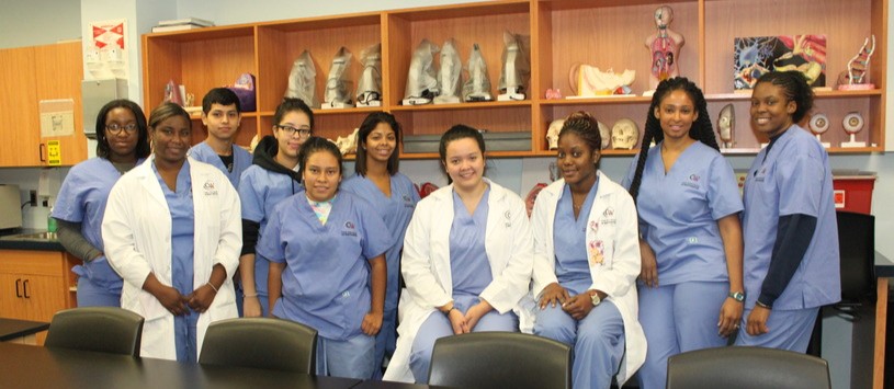 Medical Assistant Management students wearing scrubs in a classroom.