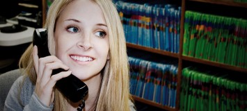 Medical Office Manager answering the phone in a medical office.