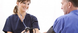 Medical Assistant taking a patient's blood pressure.